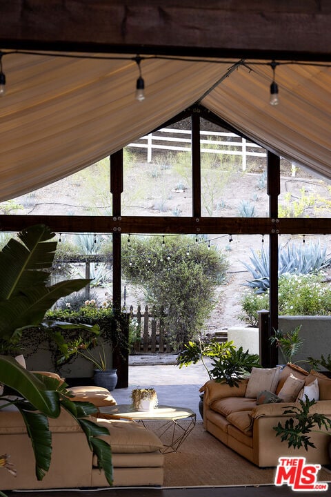 living room with wood ceiling and vaulted ceiling