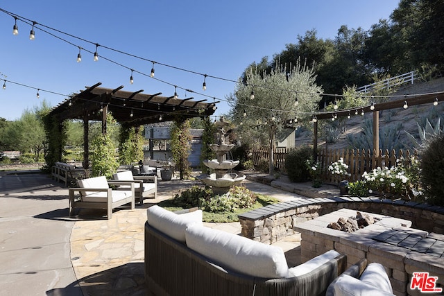 view of patio / terrace with an outdoor living space with a fire pit