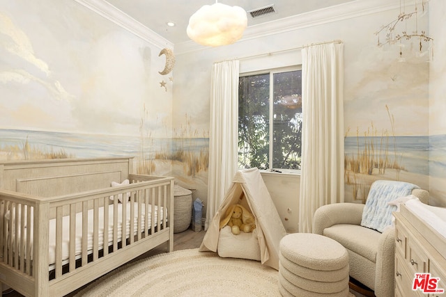 bedroom with ornamental molding and a crib