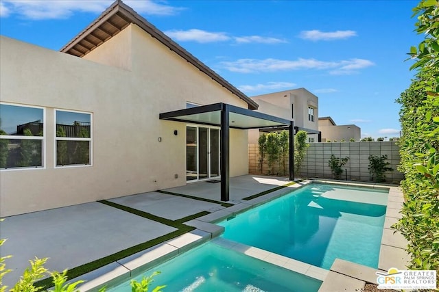 view of swimming pool featuring an in ground hot tub and a patio