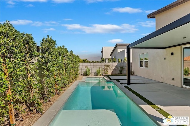 view of swimming pool featuring a patio area