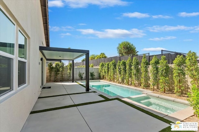 view of swimming pool featuring a patio area and an in ground hot tub