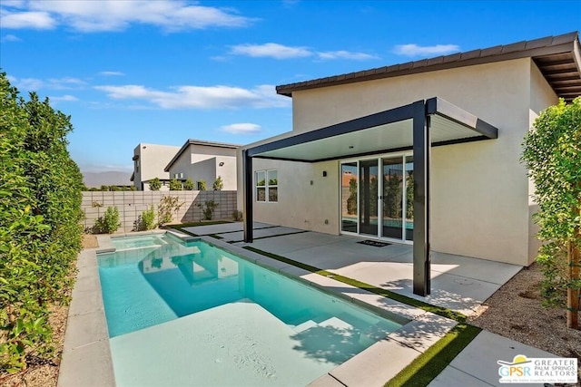 view of swimming pool featuring an in ground hot tub and a patio area