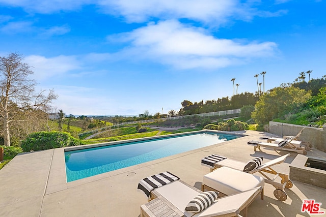 view of swimming pool featuring a patio area