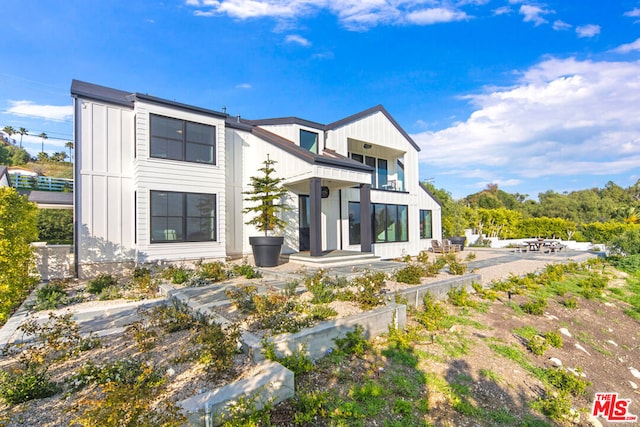 back of property featuring a balcony