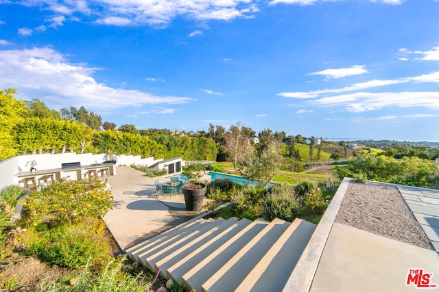 view of home's community featuring a pool and a patio