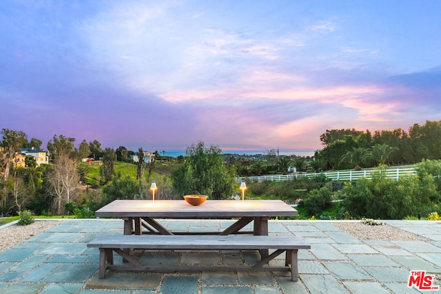 view of patio terrace at dusk