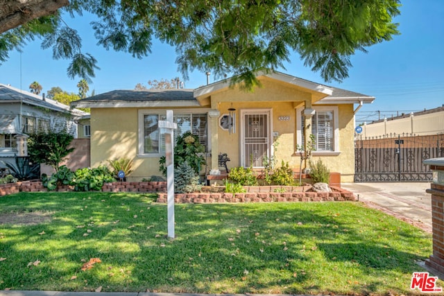 bungalow-style house with a front lawn