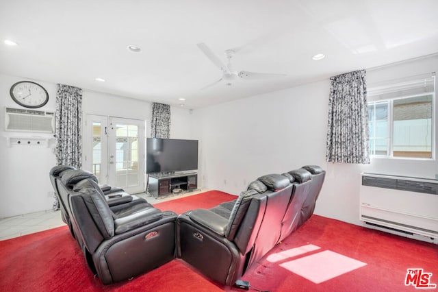 carpeted living room featuring a wall unit AC, radiator heating unit, and ceiling fan