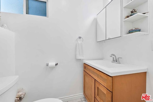 bathroom featuring toilet, vanity, and tile patterned floors