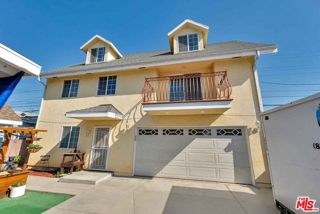 view of front facade featuring a balcony and a garage