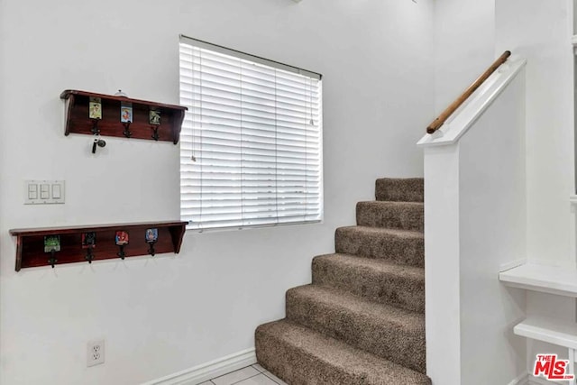 stairway with tile patterned flooring