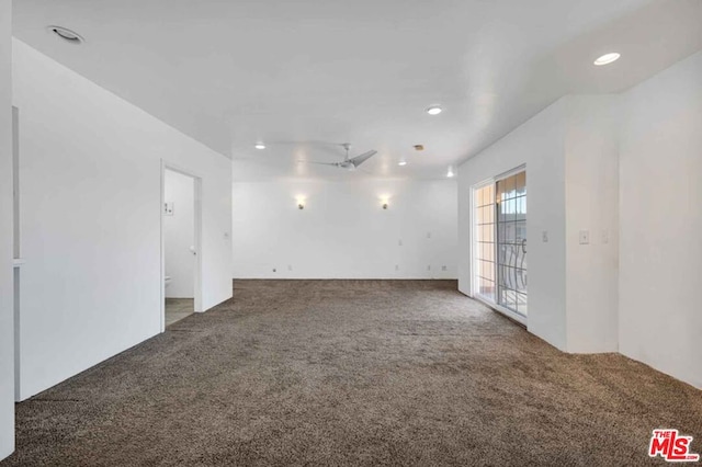 unfurnished room with ceiling fan and carpet flooring