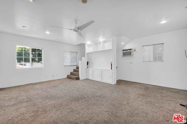 unfurnished living room featuring carpet and ceiling fan