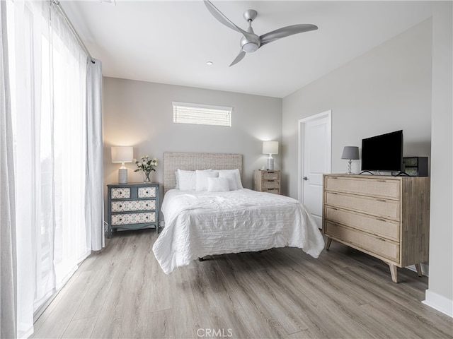 bedroom with light hardwood / wood-style flooring and ceiling fan