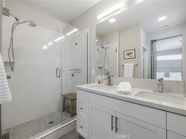 bathroom featuring walk in shower and vanity