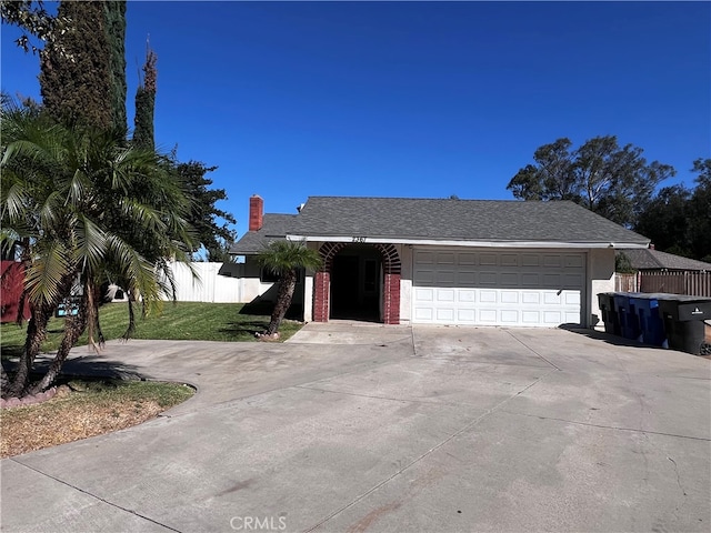 single story home featuring a front yard and a garage