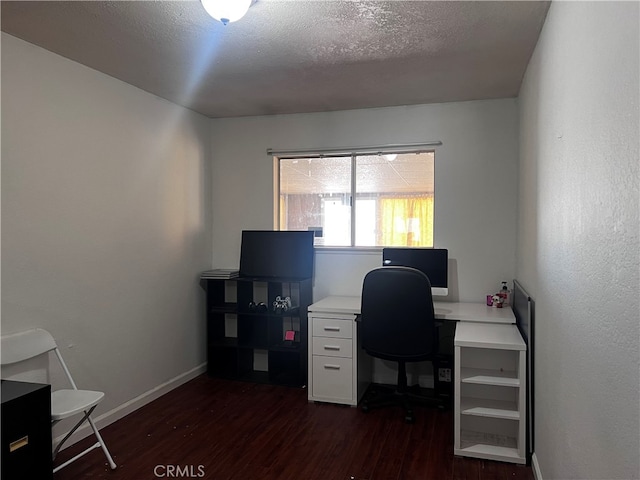 office space featuring a textured ceiling and dark hardwood / wood-style flooring