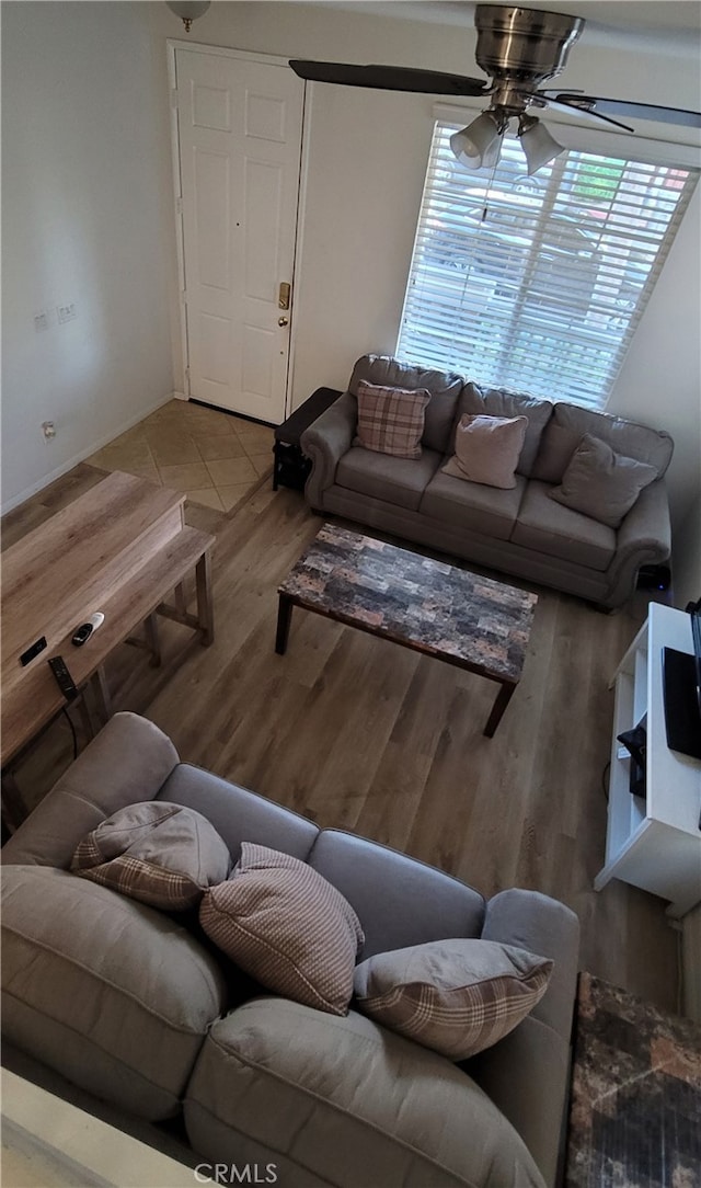 living room featuring light hardwood / wood-style flooring and ceiling fan