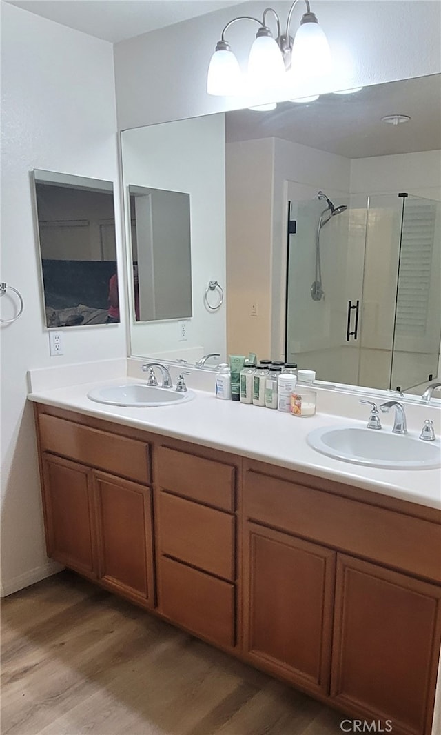 bathroom featuring vanity, hardwood / wood-style flooring, and walk in shower