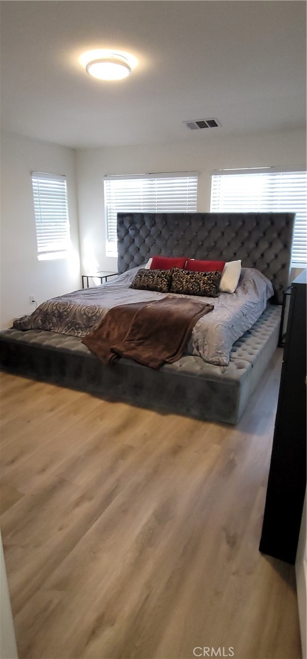 bedroom with hardwood / wood-style floors