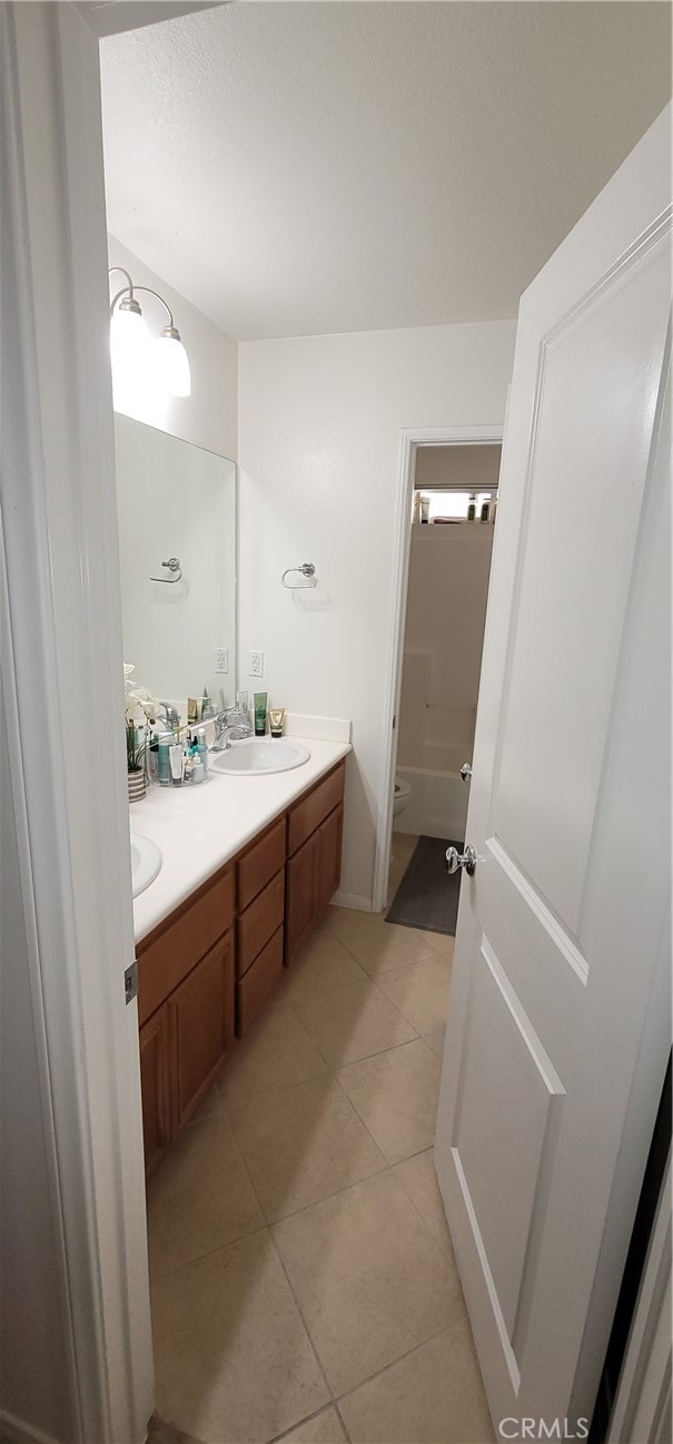 bathroom featuring vanity, toilet, and tile patterned floors