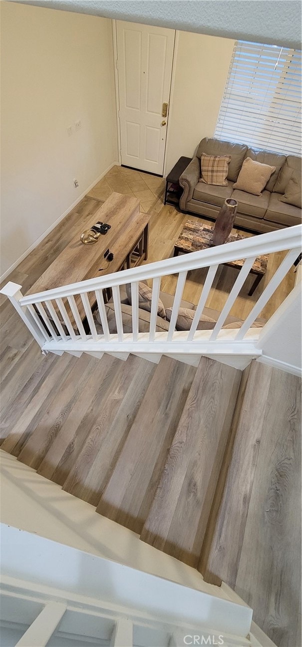 stairway with hardwood / wood-style flooring