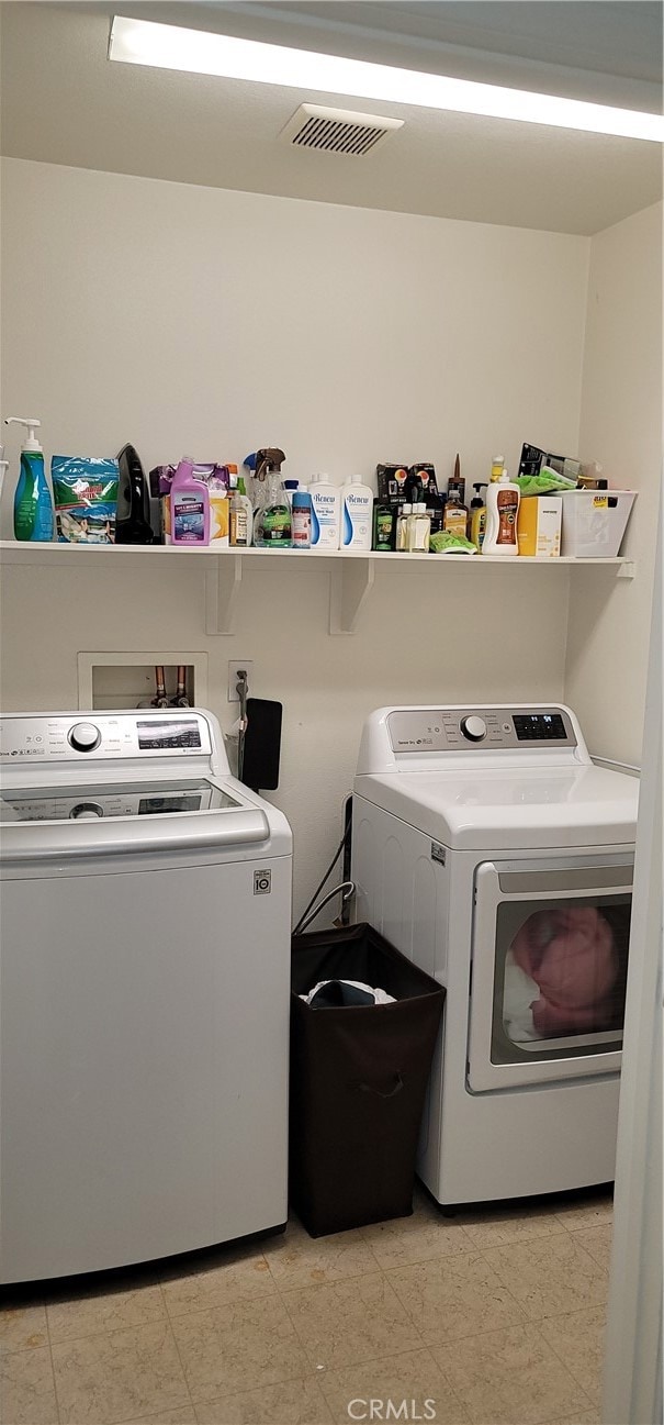 laundry room with separate washer and dryer