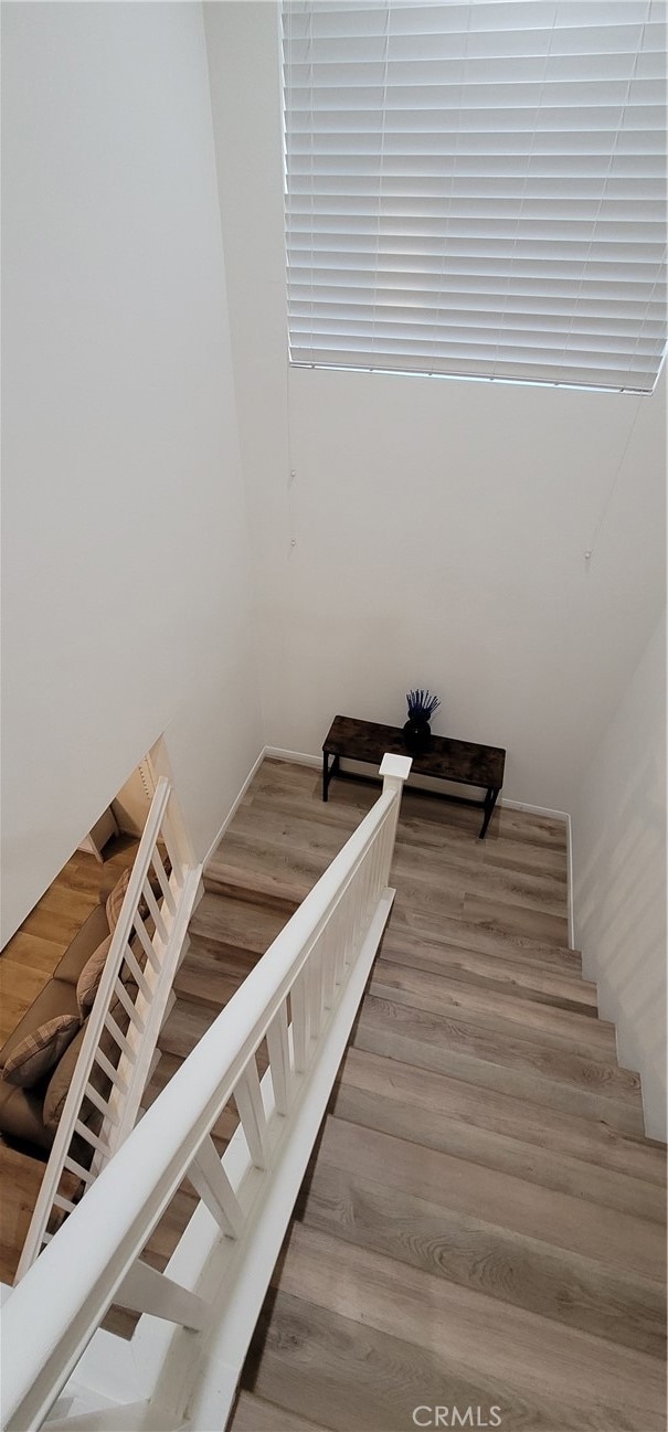 stairway with hardwood / wood-style floors