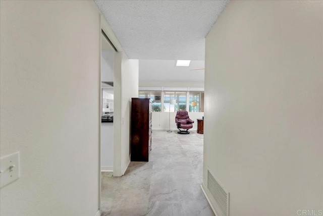 3685 Vista Campana N Unit 56, Oceanside, CA 92057 - corridor featuring baseboards and a textured ceiling