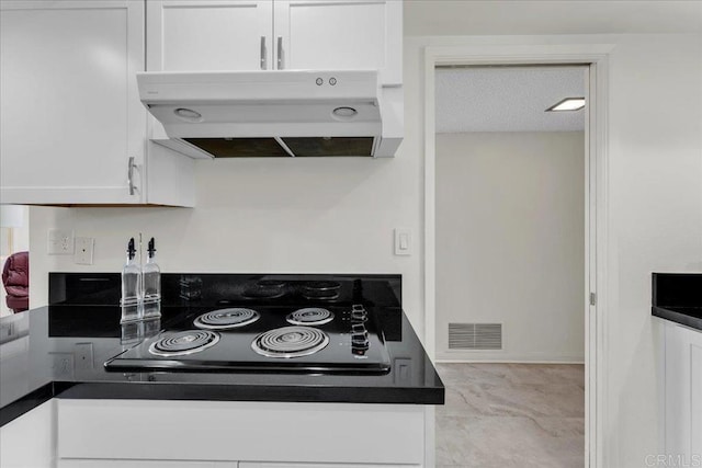3685 Vista Campana N Unit 56, Oceanside, CA 92057 - kitchen with ventilation hood, white cabinetry, black electric cooktop, dark countertops, and marble finish floors