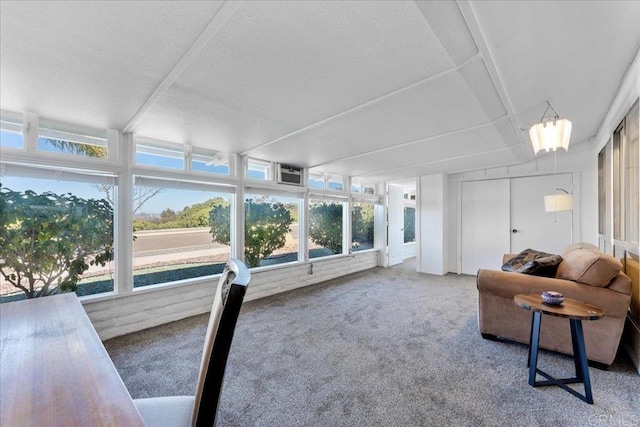 sunroom featuring a wall unit AC and a healthy amount of sunlight