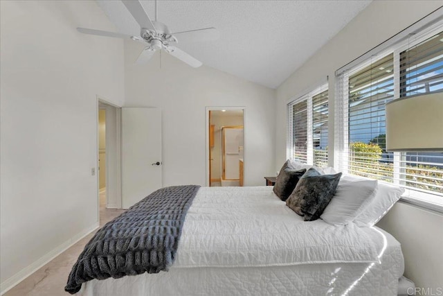 bedroom featuring a textured ceiling, ensuite bathroom, ceiling fan, and lofted ceiling