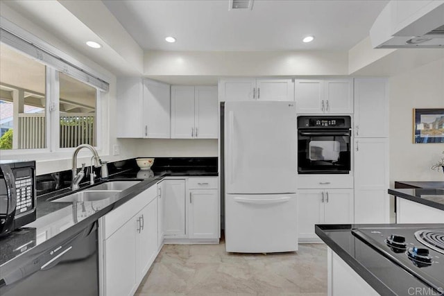 3685 Vista Campana N Unit 56, Oceanside, CA 92057 - kitchen featuring black appliances, white cabinetry, light marble finish floors, recessed lighting, and dark stone counters