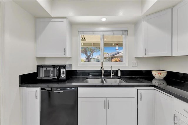 3685 Vista Campana N Unit 56, Oceanside, CA 92057 - kitchen featuring black appliances, dark countertops, and white cabinets