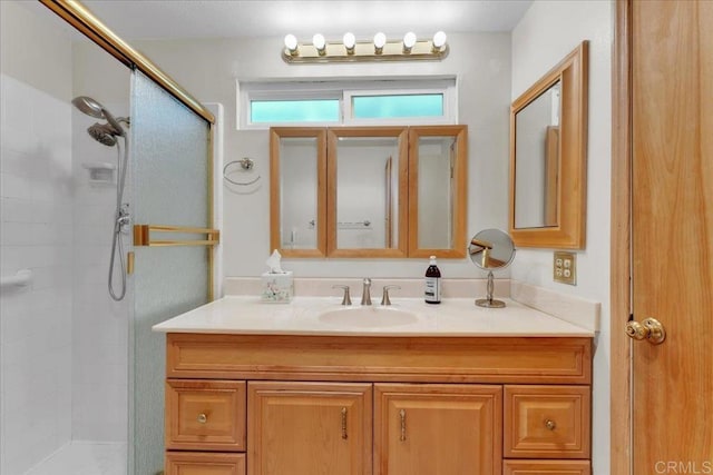 bathroom with vanity and a shower with door