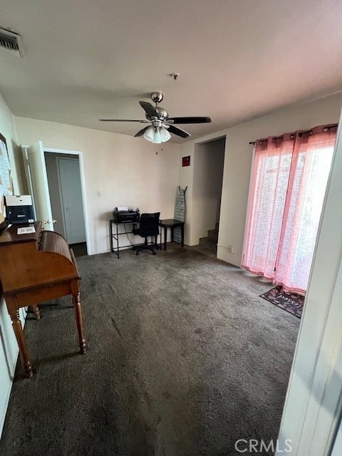 interior space with ceiling fan and dark carpet