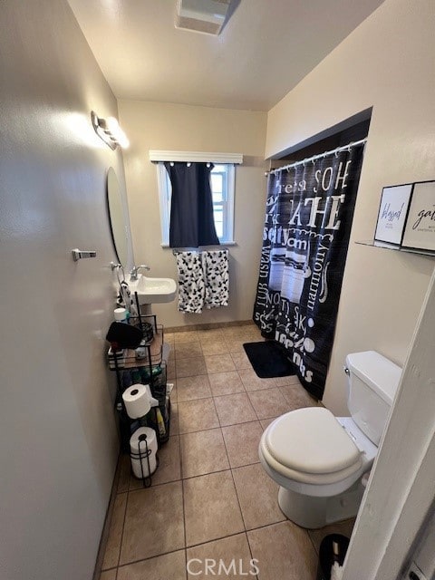 bathroom with tile patterned floors, sink, and toilet