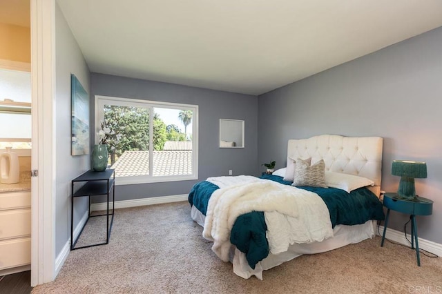 carpeted bedroom featuring ensuite bath