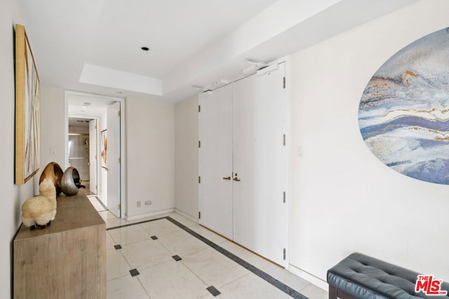 hall with light tile patterned floors