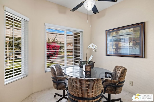 tiled dining space featuring ceiling fan