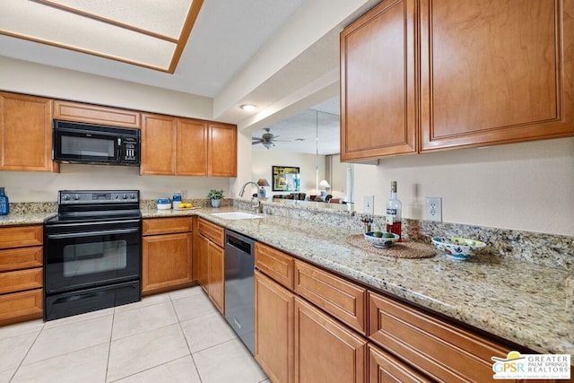 kitchen with light stone countertops, ceiling fan, sink, light tile patterned floors, and black appliances