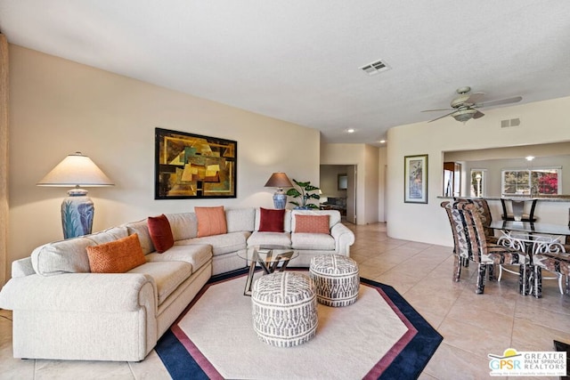 tiled living room featuring ceiling fan