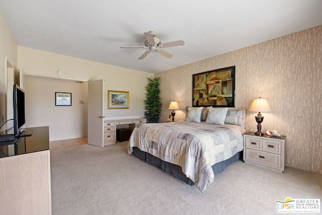 bedroom with ceiling fan and light carpet