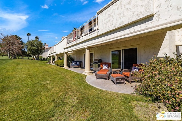 view of yard featuring outdoor lounge area, a balcony, and a patio