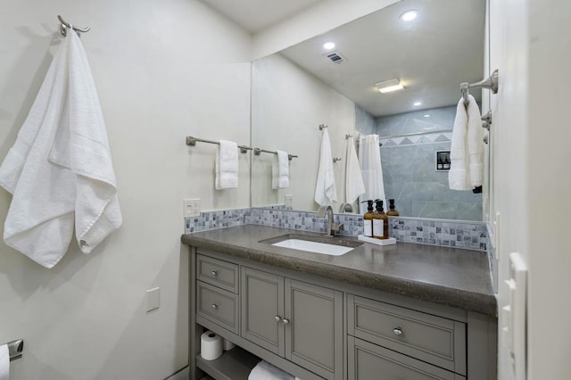 bathroom featuring vanity, a shower with shower curtain, and backsplash