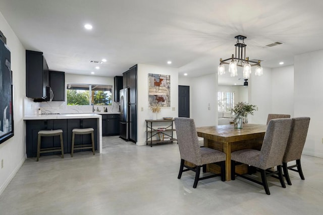 dining area featuring an inviting chandelier