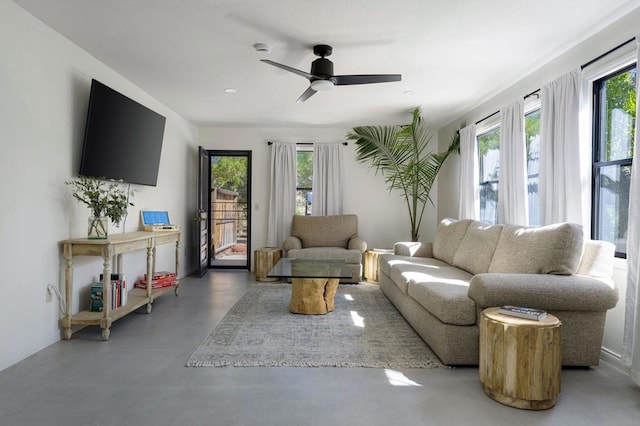 living room featuring concrete flooring and ceiling fan