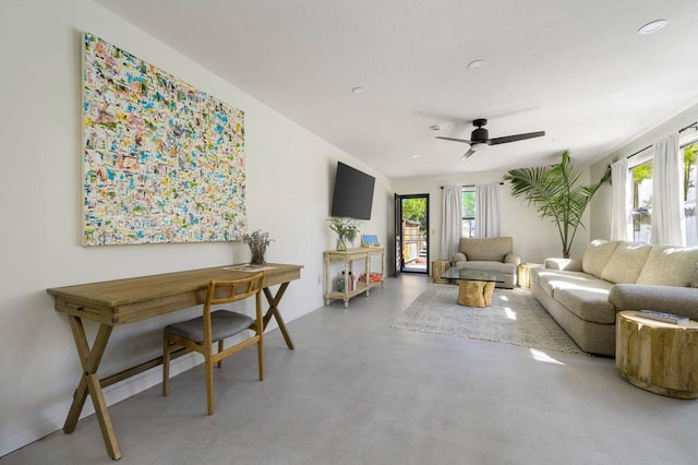 living room featuring concrete floors and ceiling fan