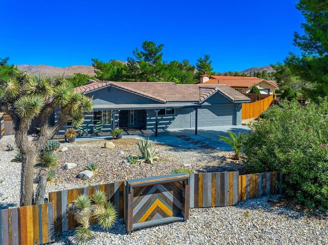 view of front of home featuring a mountain view and a garage